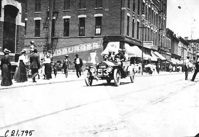 Car #53 on downtown street, 1909 Glidden Tour
