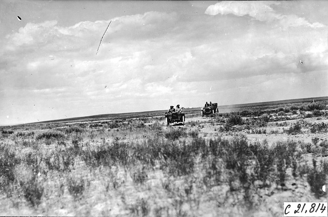 Moline car driven by J.M. Wicks and a vehicle close behind on the Iowa prairie, at the 1909 Glidden Tour