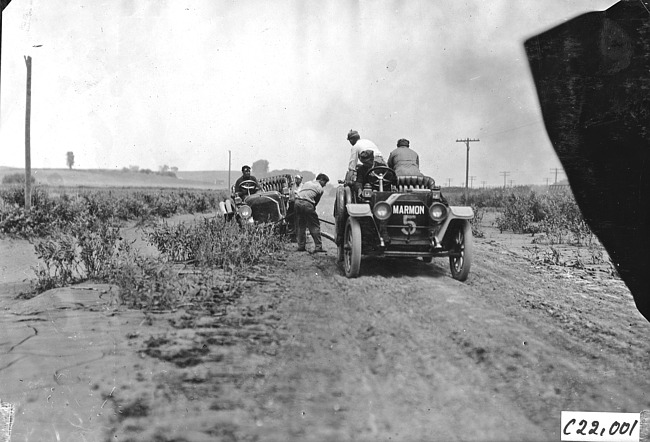 H.C. Marmon in Marmon car pulls unidentified Glidden tourist vehicle from mud hole near Arion, Iowa at the 1909 Glidden Tour
