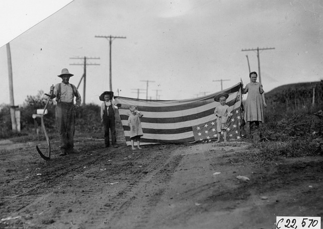 Kelley twins and their flag at Chapman, Neb., at the 1909 Glidden Tour