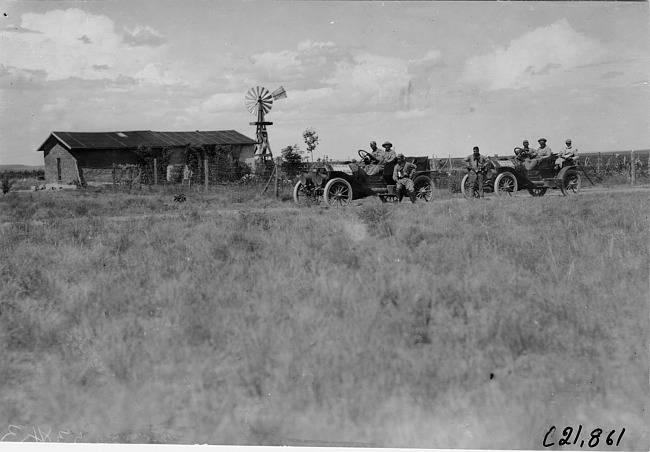 Glidden tourists in Moline cars pose in front of farm house near Kearney, Neb., at 1909 Glidden Tour