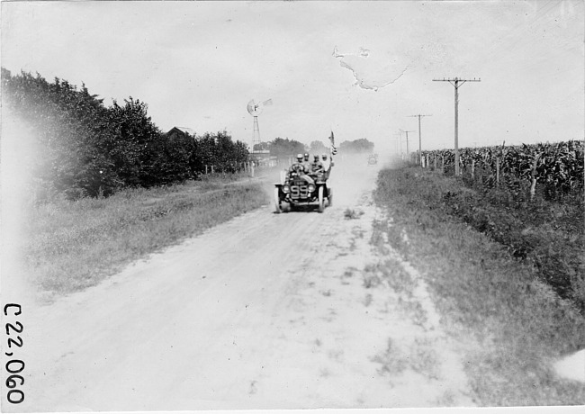 Car #99 on rural road passing farmhouse near Kearney, Neb., at 1909 Glidden Tour