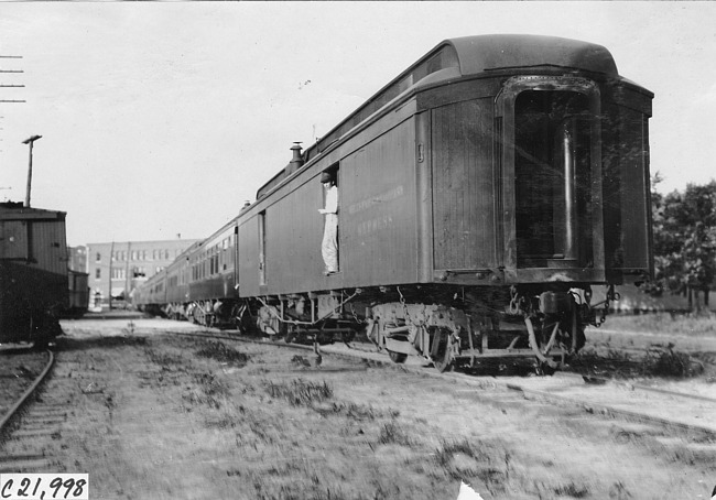 Man standing in doorway of Pullman car in Kearney, Neb., at 1909 Glidden Tour