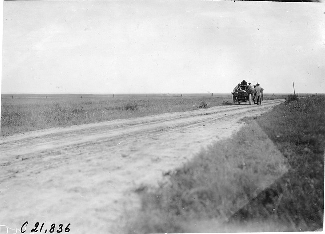 Driver George Schuster in Thomas car #76 on the prairie wilds in Neb., at the 1909 Glidden Tour