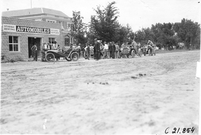 Glidden tourists stopped in front of an automobile store at Ft. Morgan, Colo., at 1909 Glidden Tour