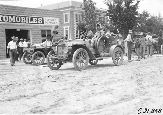 Duesenberg in Mason stopped in front of an automobile store at Ft. Morgan, Colo., at 1909 Glidden Tour