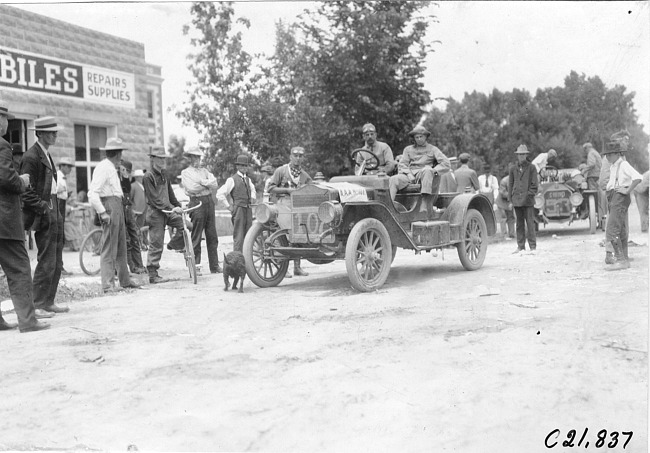 Goldthwaite in Maxwell car stopped in front of automobile store at Ft. Morgan, Colo., at 1909 Glidden Tour