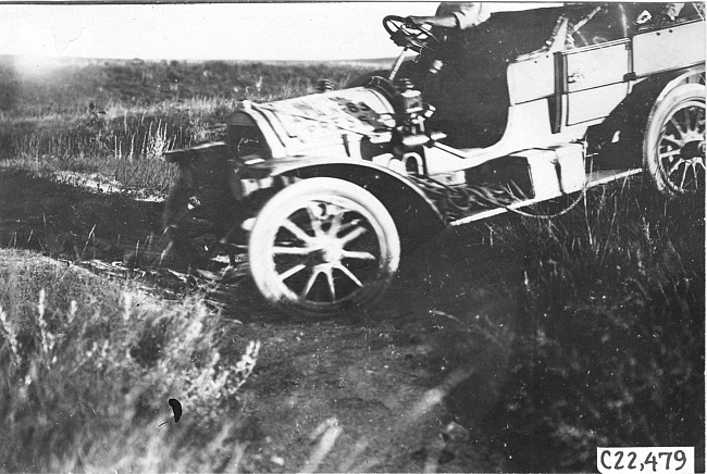 Close up of the front wheels of a press car on the Colorado prairie, at 1909 Glidden Tour
