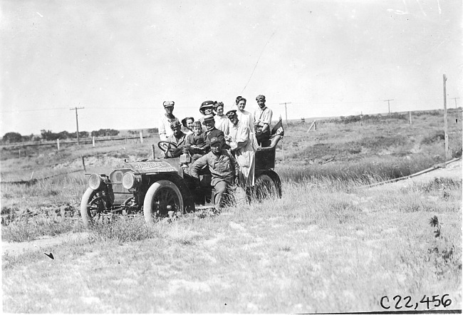 Locals pose with Glidden tourists in Studebaker press car near Aurora, Colo., at 1909 Glidden Tour