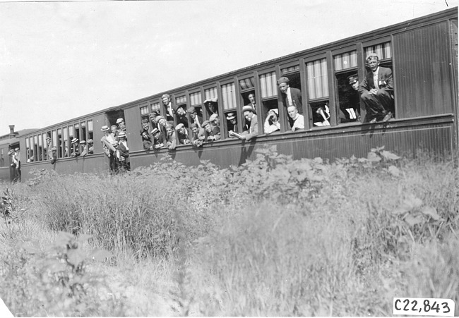 Glidden tourists look out from railroad cars headed for Mt. McClellan, Colo., at 1909 Glidden Tour