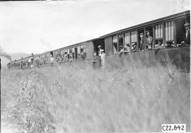 Glidden tourists look out from railroad cars headed for Mt. McClellan, Colo., at 1909 Glidden Tour