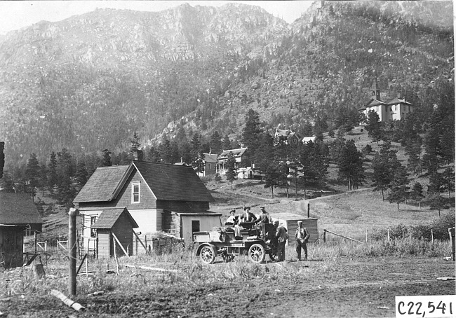 Houses and a church in the Colorado mountains, at 1909 Glidden Tour
