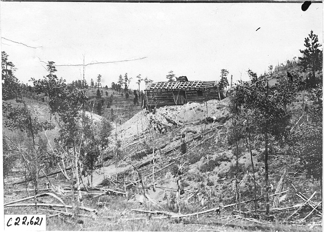 Log cabin in the mountains in Colo., at 1909 Glidden Tour