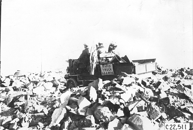 Rapid motor truck stuck in the rocks on a mountain road in Colo., at 1909 Glidden Tour