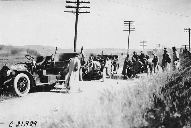 Studebaker press car and other Glidden tourist vehicles stopped along a rural road in Colo., at 1909 Glidden Tour