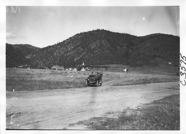 Smithson in Studebaker Press car on rural road in Colo., at 1909 Glidden Tour