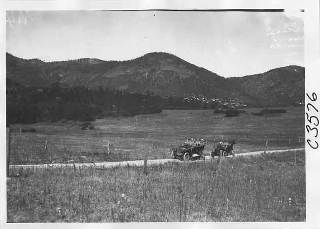 Studebaker press car and Stanley steamer car on rural road in Colo., at 1909 Glidden Tour
