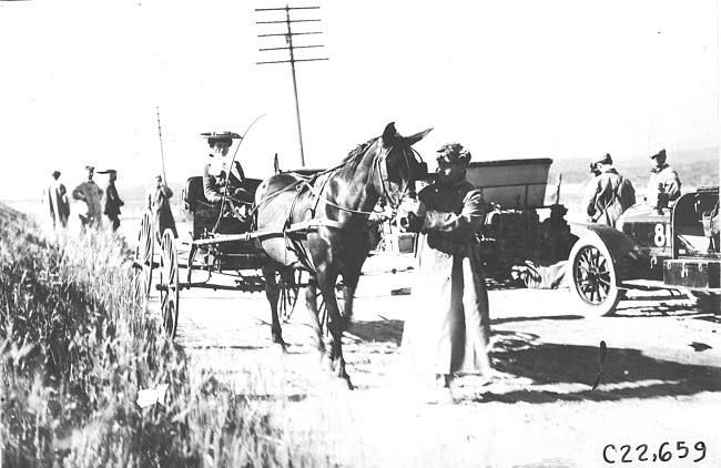 Woman in horse-drawn vehicle stopped on rural road near Colorado Springs, Colo., at 1909 Glidden Tour