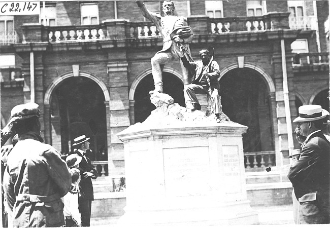 Glidden tourist posed with statue of Zebulon Pike in front of Antlers Hotel in Colorado Springs, Colo., at 1909 Glidden Tour