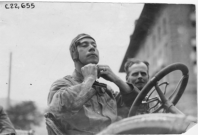 Participant fastening hat in Colorado Springs, Colo., at the 1909 Glidden Tour