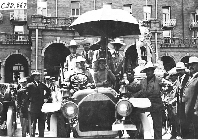 Participants with large umbrella in Colorado Springs, Colo., at the 1909 Glidden Tour