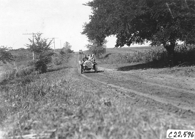 Jean Bemb in Chalmers car on rural road in Kansas, at 1909 Glidden Tour