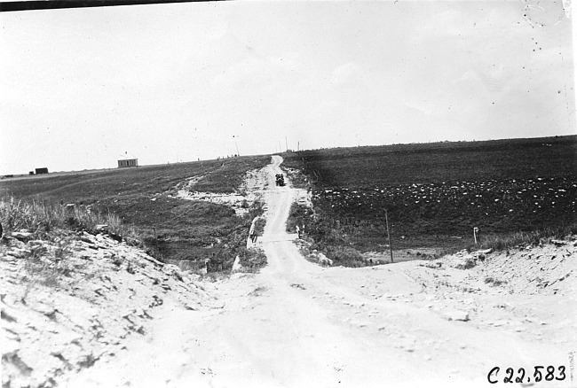 Webb Jay in Premier car on sandy road near Bunker Hill, Kan., at 1909 Glidden Tour