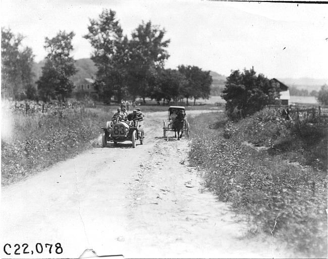 Glidden tourist car #83 passing horse-drawn vehicle on rural road near Junction City, Kan., at 1909 Glidden Tour