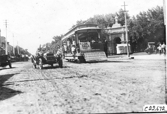 Maxwell car next to street car in Junction City, Kan., at 1909 Glidden Tour