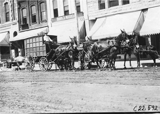 Horse-drawn vehicle parked in front of market in Junction City, Kan., at 1909 Glidden Tour