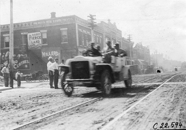 Searles in White Steamer car on city street in Junction City, Kan., at 1909 Glidden Tour
