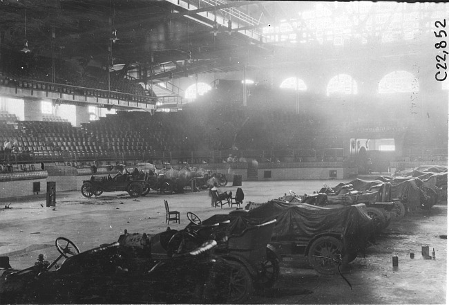 Two lines of cars parked inside the convention hall at Kansas City, Mo., at 1909 Glidden Tour