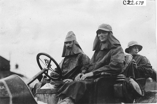 Crew of the Lexington car in rain gear, at 1909 Glidden Tour