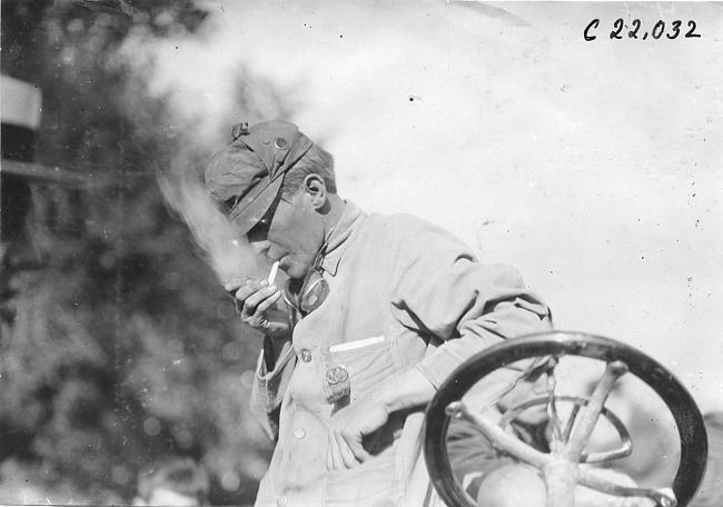 John Machesky stands near car, at 1909 Glidden Tour
