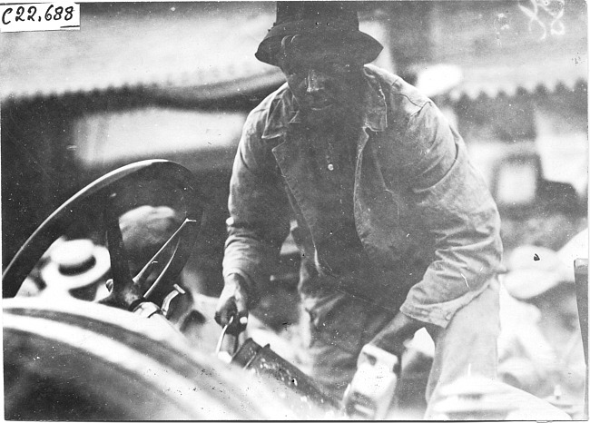 John Williams working on car, at 1909 Glidden Tour