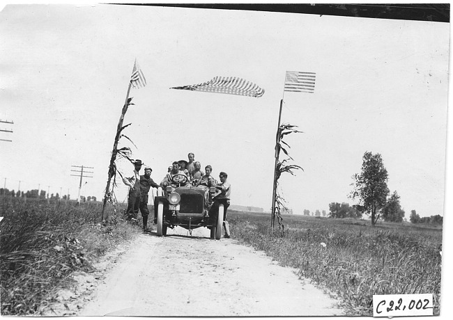 Smithson in Studebaker car on rural road, at 1909 Glidden Tour