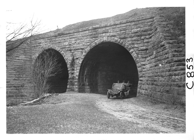 E.M.F. car exiting stone tunnel, on pathfinder tour for 1909 Glidden Tour