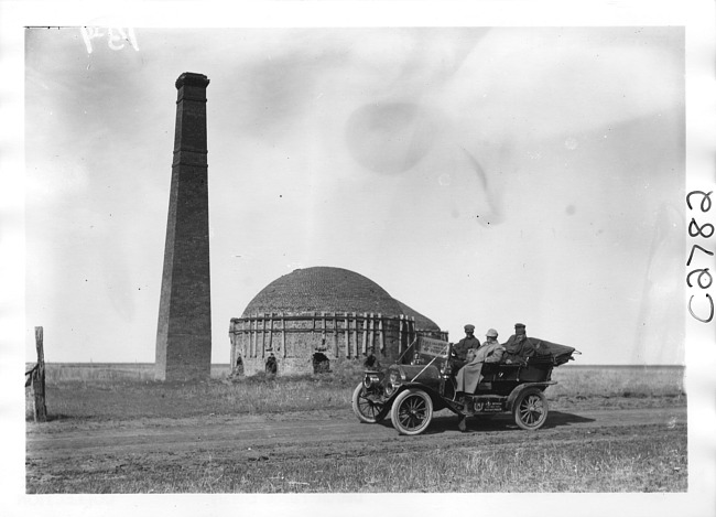 E.M.F. car passing by kiln, on pathfinder tour for 1909 Glidden Tour