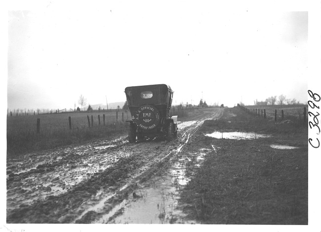 E.M.F. car on muddy, rural road, on pathfinder tour for 1909 Glidden Tour