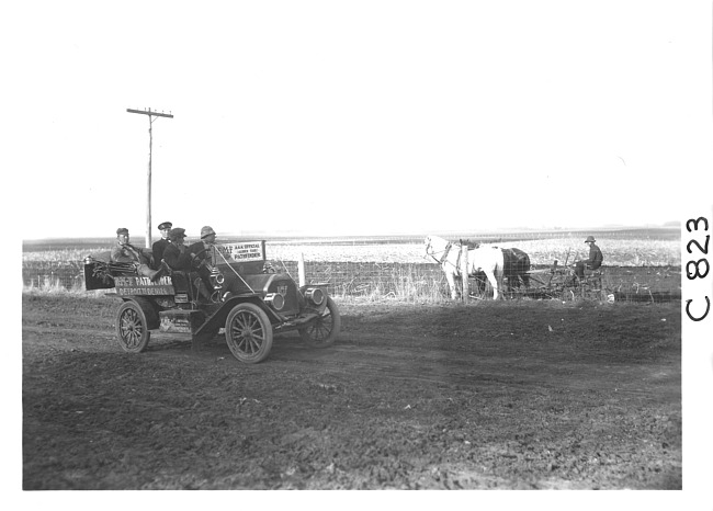 E.M.F. car on rural road near horse-drawn plow, on pathfinder tour for 1909 Glidden Tour