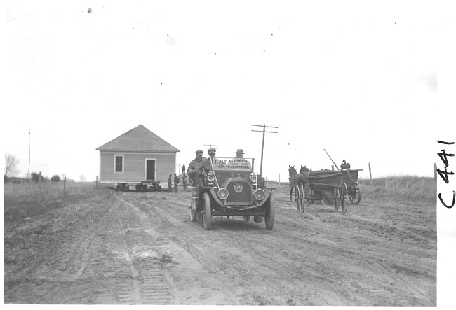 E.M.F. car passing horse-drawn vehicle on rural road, on pathfinder tour for 1909 Glidden Tour