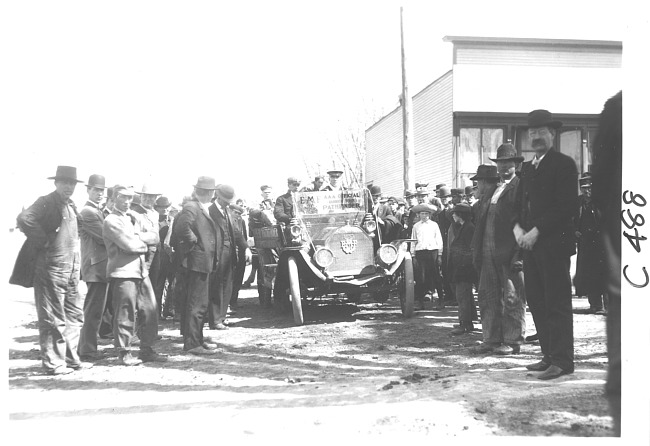 E.M.F. car surrounded by a group of men and boys, on pathfinder tour for 1909 Glidden Tour