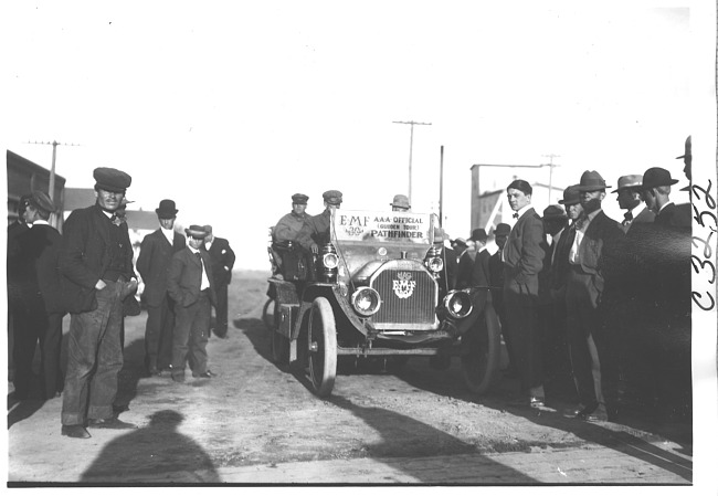 E.M.F. car surrounded by a group of men, on pathfinder tour for 1909 Glidden Tour