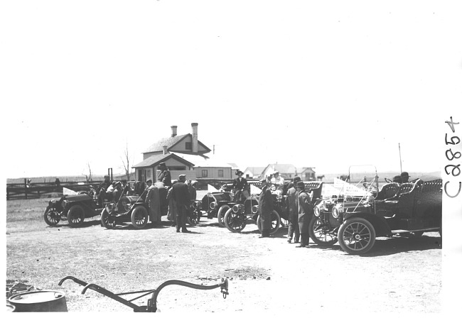 E.M.F. car surrounded by other cars, on pathfinder tour for 1909 Glidden Tour