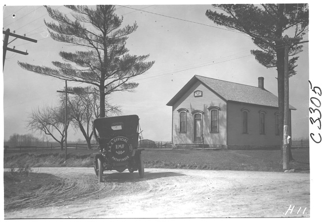 E.M.F. car passing a school, on pathfinder tour for 1909 Glidden Tour