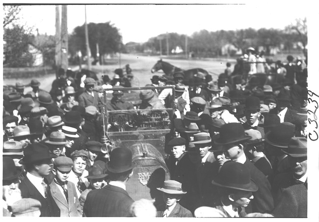 E.M.F. car surrounded by a group of men and boys, on pathfinder tour for 1909 Glidden Tour