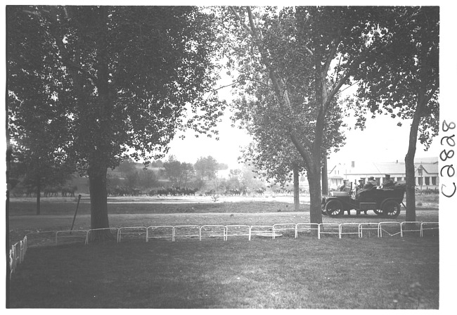 E.M.F. car stopped on road, men on horses in background, on pathfinder tour for 1909 Glidden Tour
