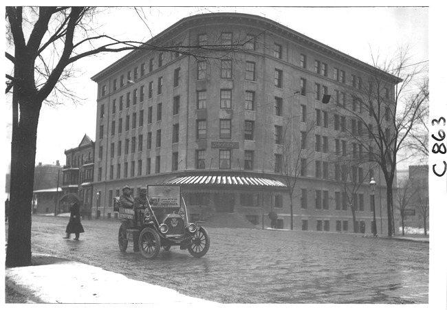 E.M.F. car on cobblestone street in rain, on pathfinder tour for 1909 Glidden Tour