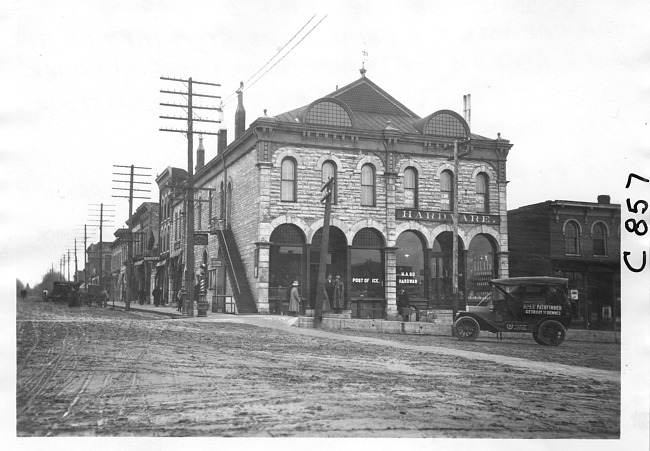 E.M.F. car in front of hardware store, on pathfinder tour for 1909 Glidden Tour