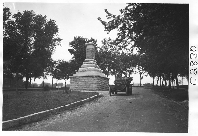 E.M.F. car by stone monument, on pathfinder tour for 1909 Glidden Tour